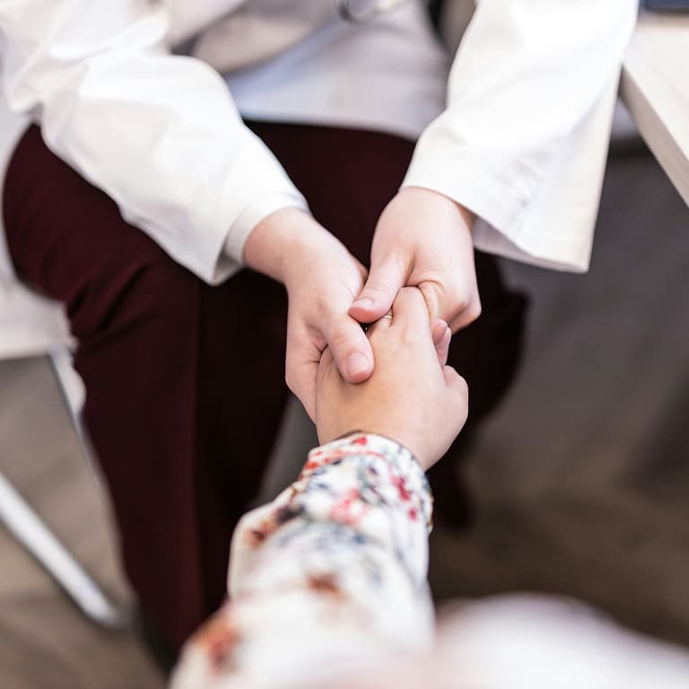 Someone extending their hand as a symbol of health and wellness, representing care, support and well-being